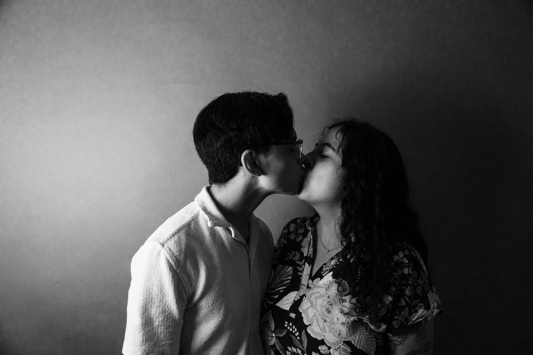 Black and white portrait of a couple leaning close together.